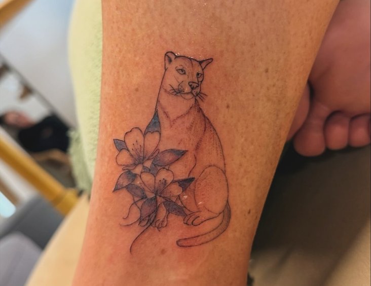 Close-up of a hand holding a small tattoo stencil