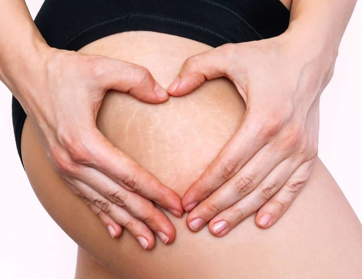 Close-up of a hand holding a small tattoo stencil